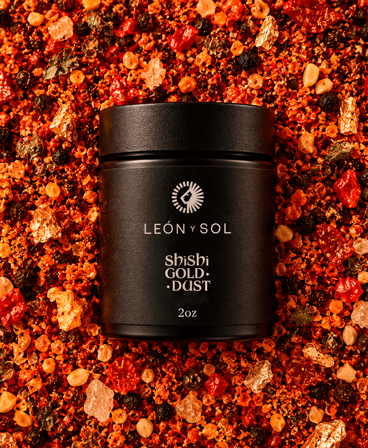 León Y Sol Shishi Gold Dust 2 oz bottle with copper label beside a gold-rimmed cocktail
